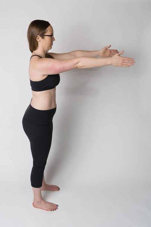 Jessie stands facing to the side, demonstrating a "rib thrusted" body position with her arms extended straight out in front of her and pushing her chest up towards the sky. This image is part of an explanation about how body positions relate to healing diastasis recti.